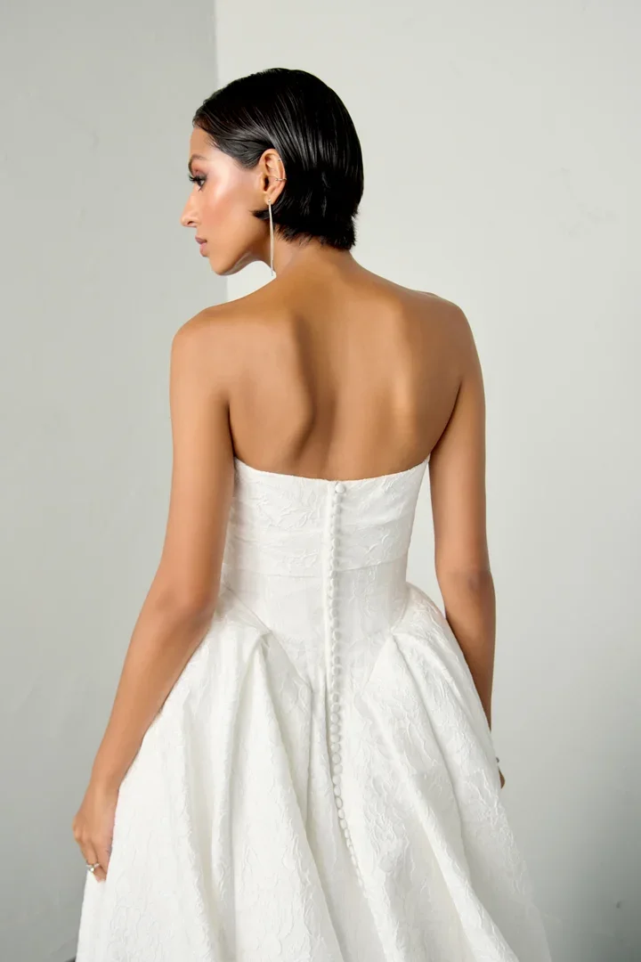 Bride wearing the Justin Alexander Signature 99388 couture wedding dress with elegant structured silhouette and luxury bridal detailing