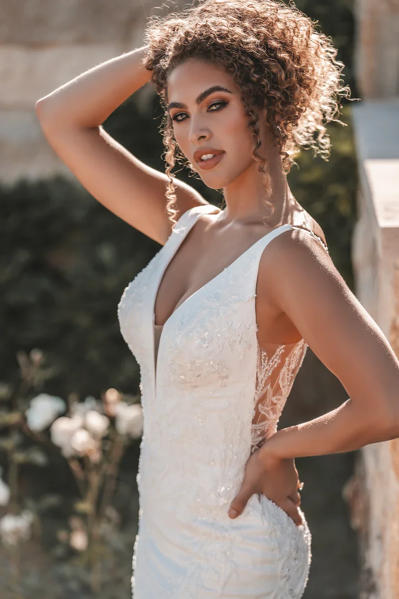 Allure Bridals A1201 sleeveless V-neck sheath wedding gown in soft crepe with tonal beading, sequins, and pearled lace appliques.