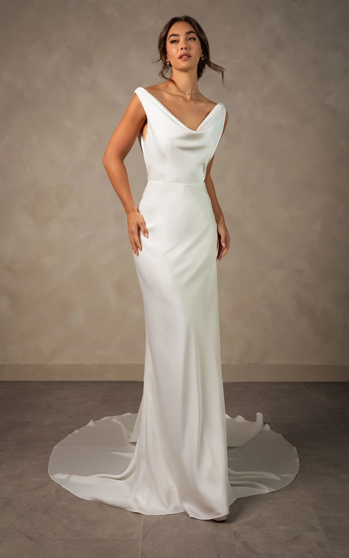 Essense of Australia D4574 minimalist satin sheath wedding gown with cowl neckline, spaghetti straps, sleek silhouette, dramatic backless design, and graceful train.