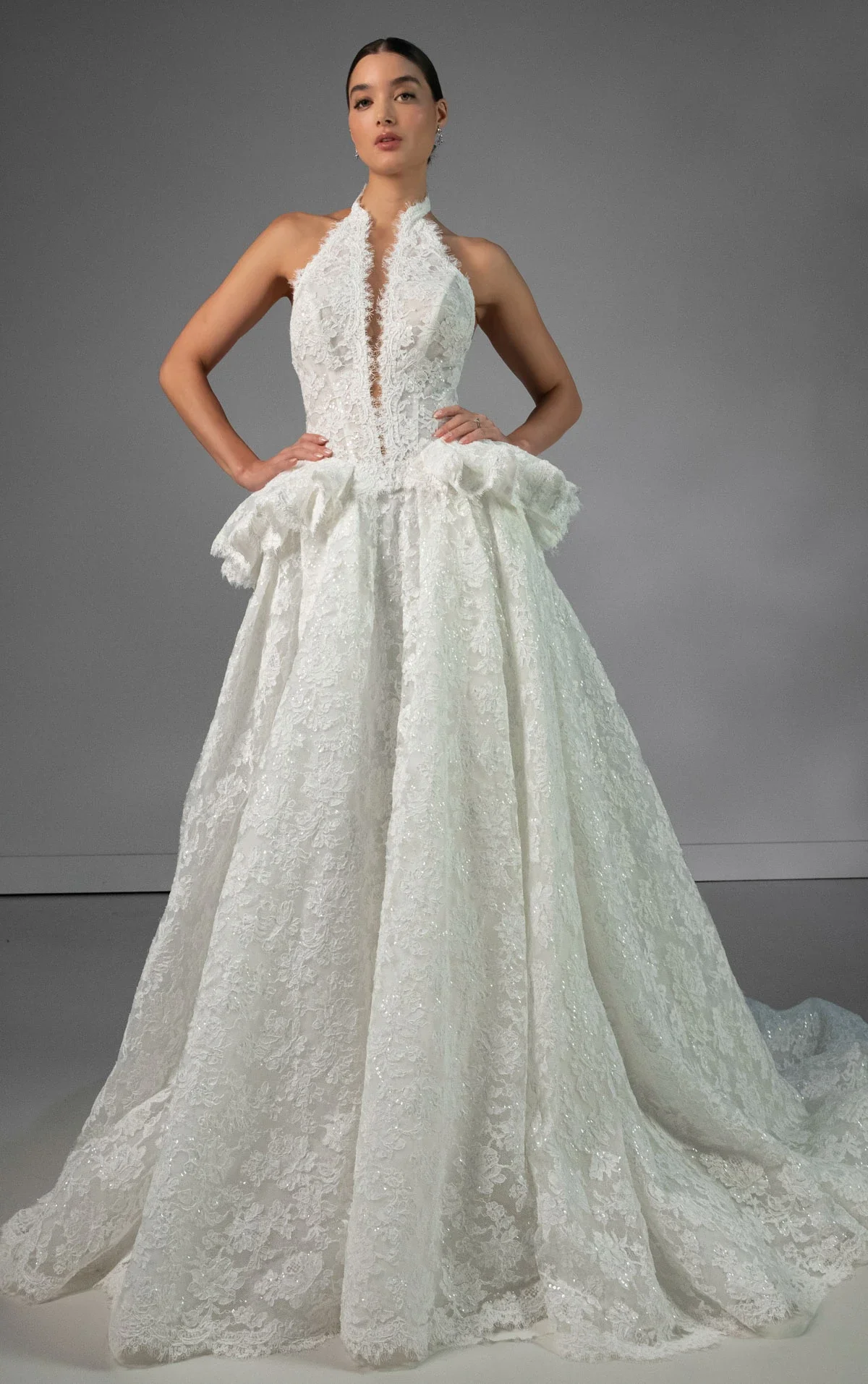 Designer lace ball gown wedding dress with halter neckline, illusion plunge bodice, dropped waist, and full A-line skirt at Bride To Be Couture Sacramento