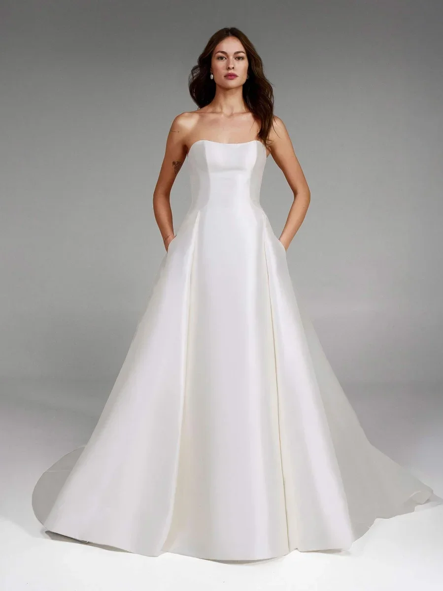 Pronovias Jory strapless princess ball gown in Kelly Mikado with detachable lace jacket and sweeping full skirt with open back.