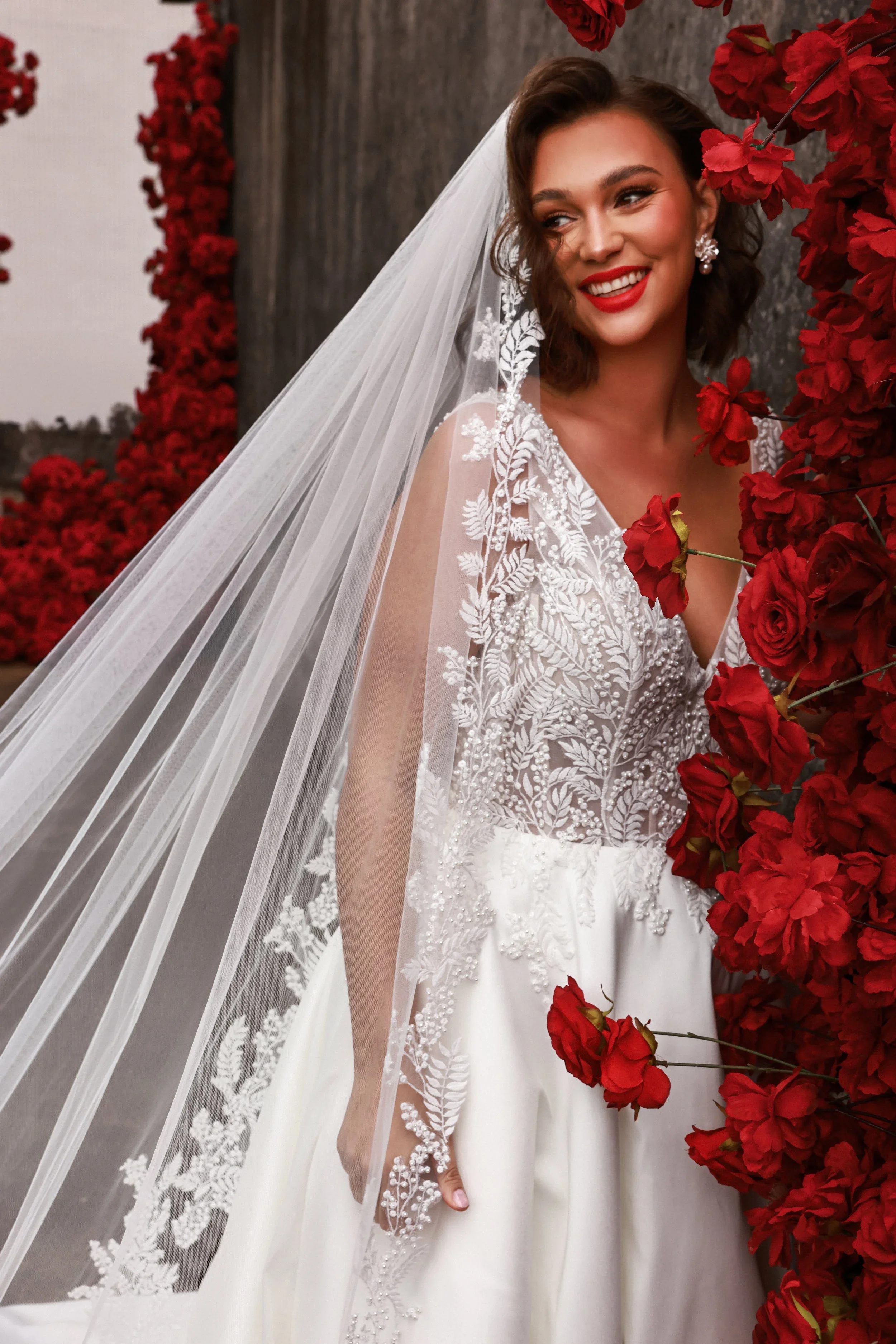 Dany Tabet Roux DG0025W495 plus size A-line wedding dress with plunging V-neckline, tank straps, beaded lace bodice, satin skirt, and subtle slit.