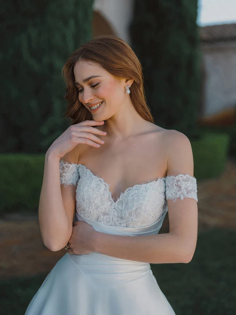 Allure Bridals A1479 off-the-shoulder sweetheart satin ballgown with beaded lace bodice, ruched basque waist, available at Bride To Be Couture in Sacramento.