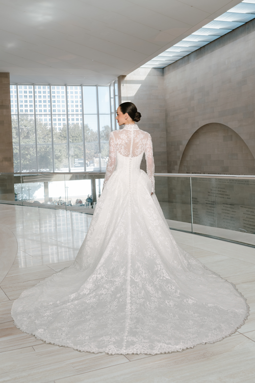 Elizabeth Lee Ashtyn beaded Chantilly lace ballgown with a V-neck long-sleeve bolero and button back detail, available at Bride To Be Couture in Sacramento.