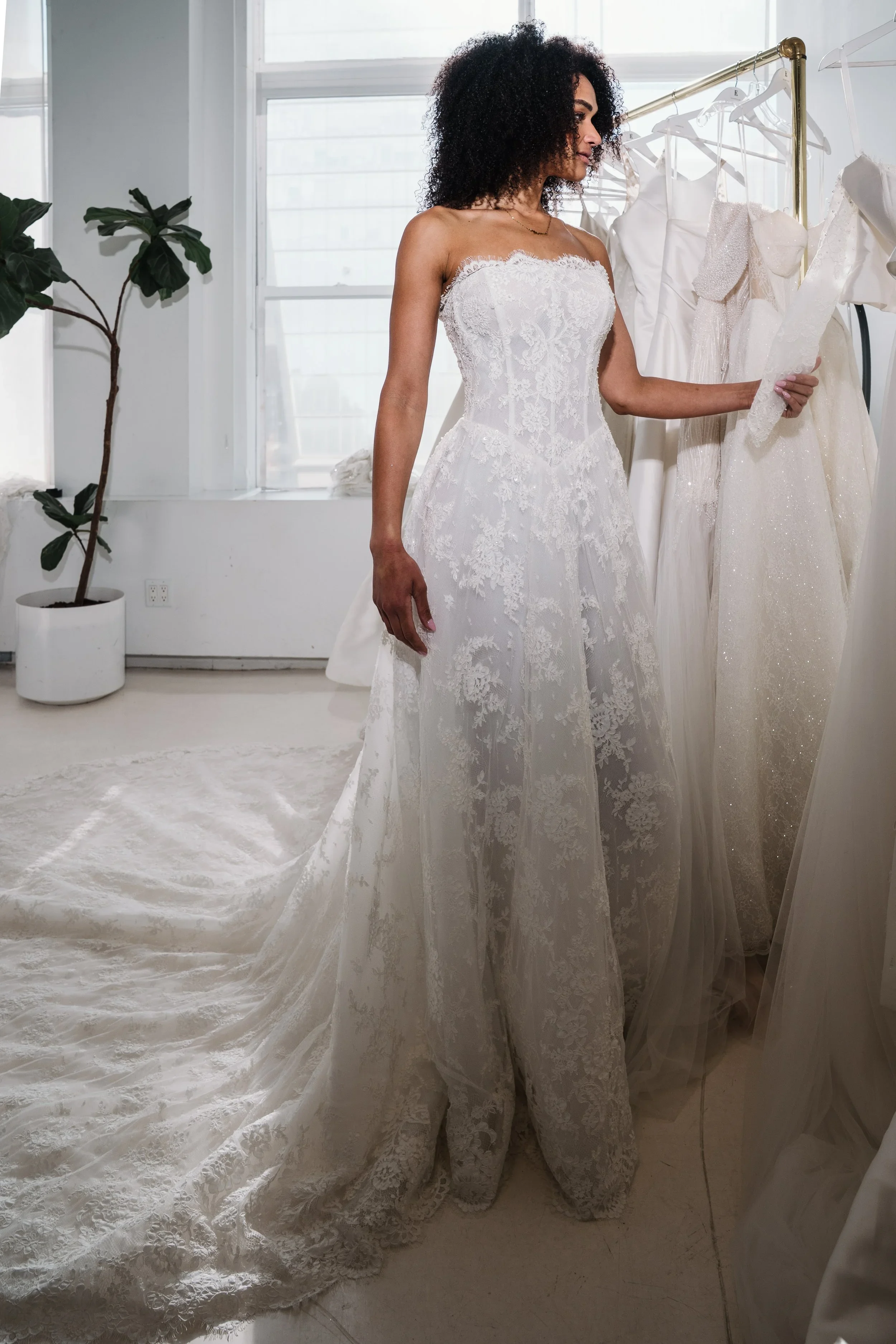 Elizabeth Lee Lorelei romantic floral lace A-line wedding dress with strapless sweetheart neckline, detachable sleeves, and long lace train.