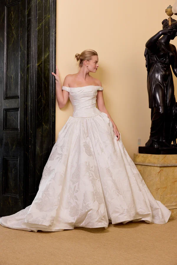 The Eloide gown, crafted from luxurious jacquard satin, features a chic two-piece design perfect for any wedding setting.