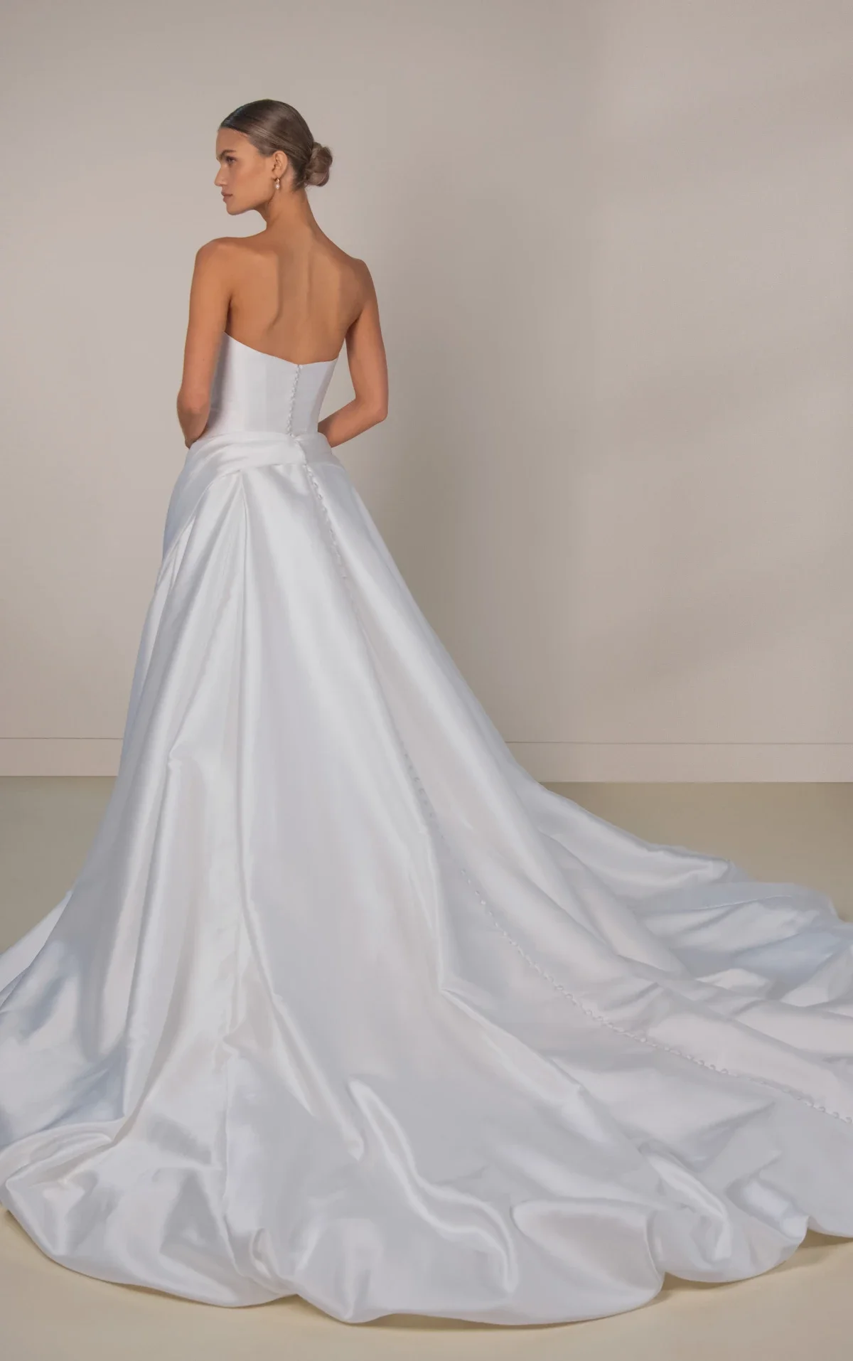 Martina Liana Luxe LE1460 strapless satin wedding dress with corset bodice, column silhouette, dramatic overskirt, and opera gloves at Bride To Be Couture Sacramento