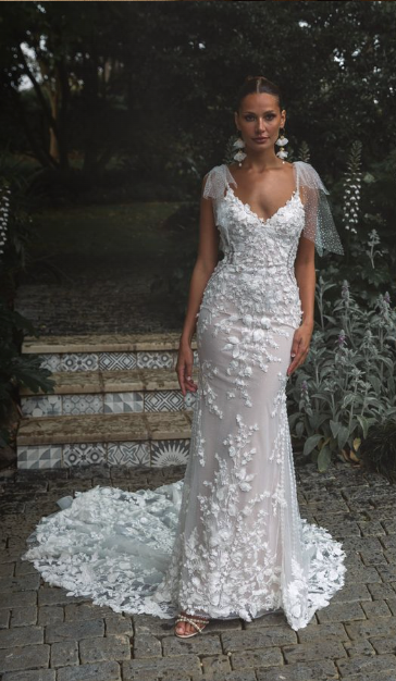 Madi Lane Penni fit-and-flare wedding dress with a sweetheart bodice, beaded tulle straps, 3D floral details, and shimmering glitter tulle with detachable glitter bows.