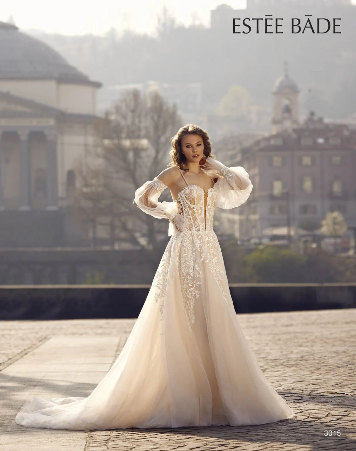 Madam Burcu Style 3015 A-line wedding gown with floral lace bodice, tulle skirt, and detachable bishop sleeves in ivory