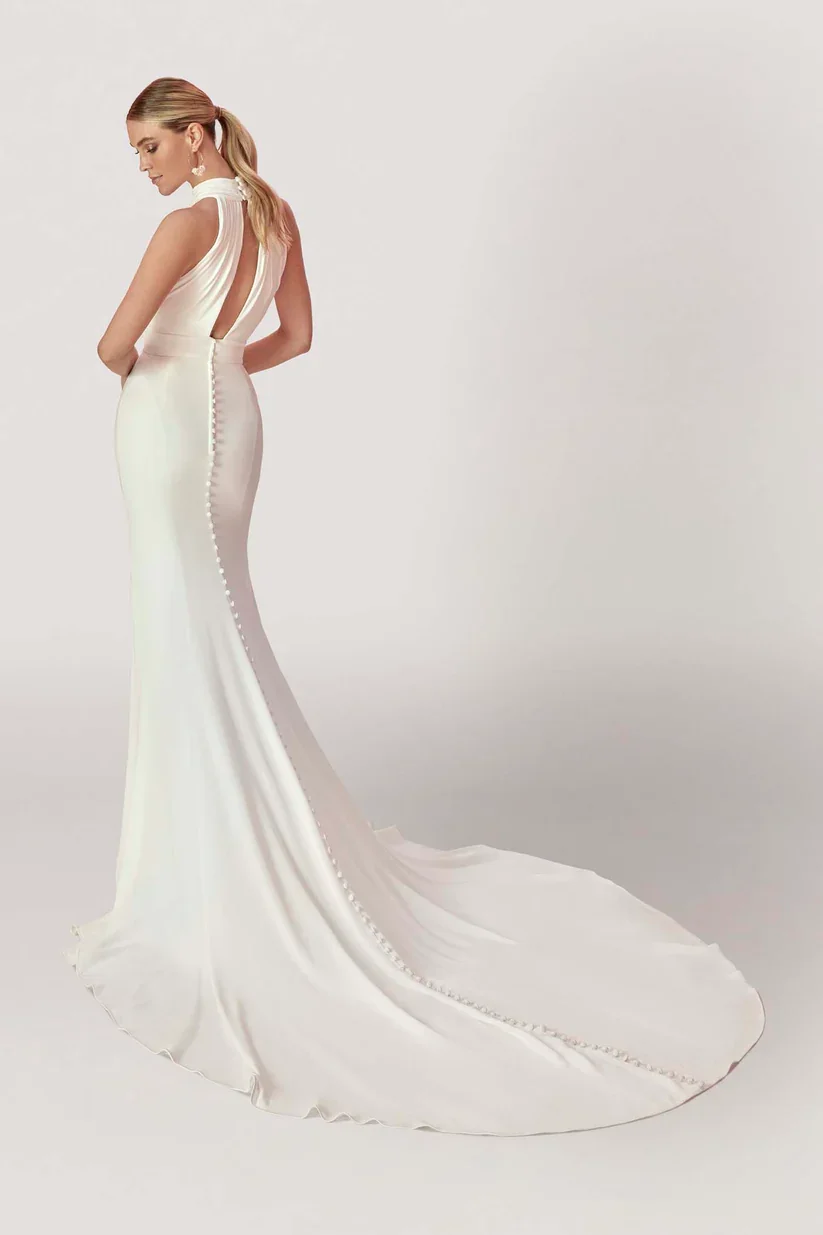 Madison James Goldie Old Hollywood-inspired satin sheath wedding gown with gathered halter neckline and draped silhouette.