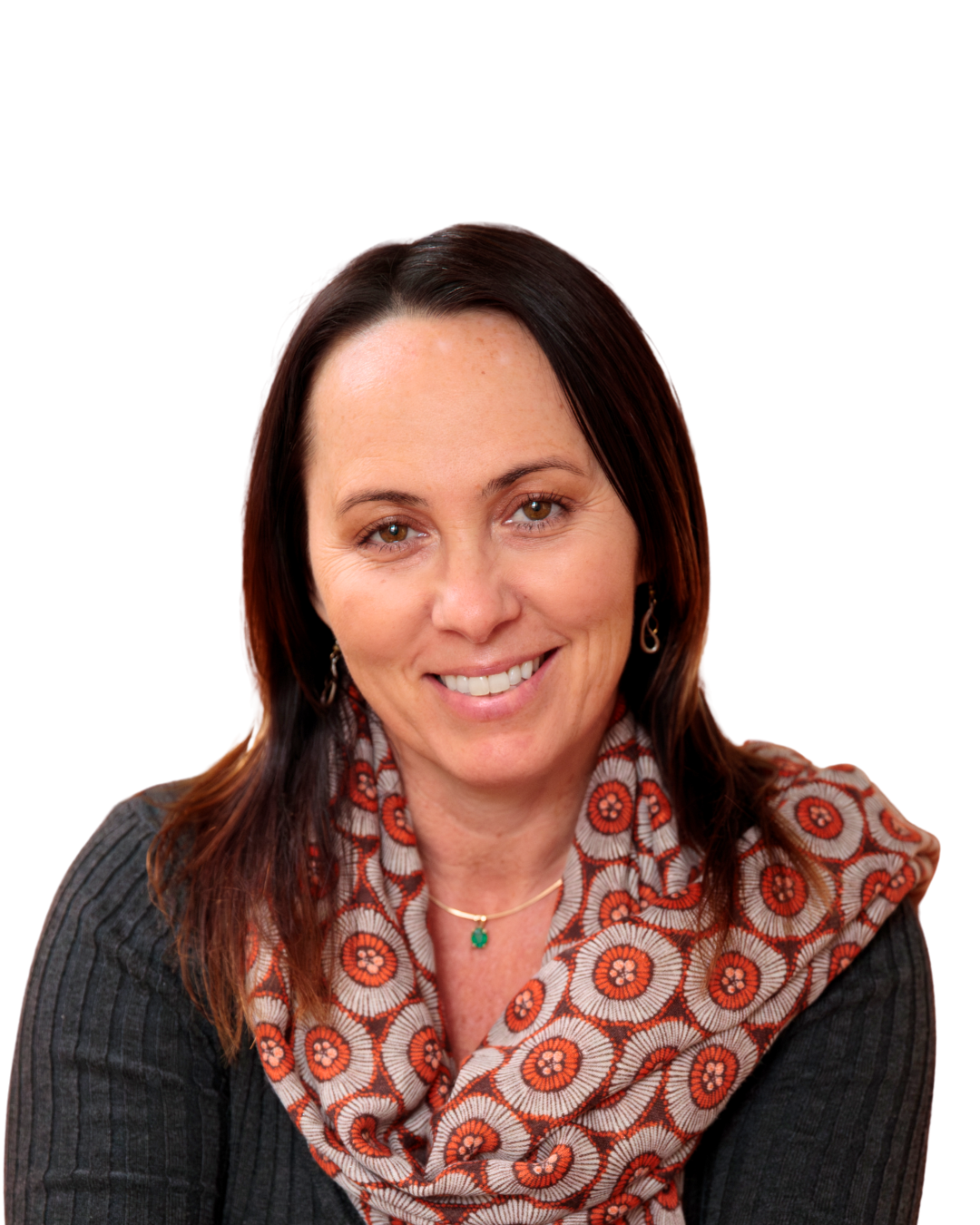 A woman with brown hair wearing a patterned scarf and dark sweater, smiling at the camera.