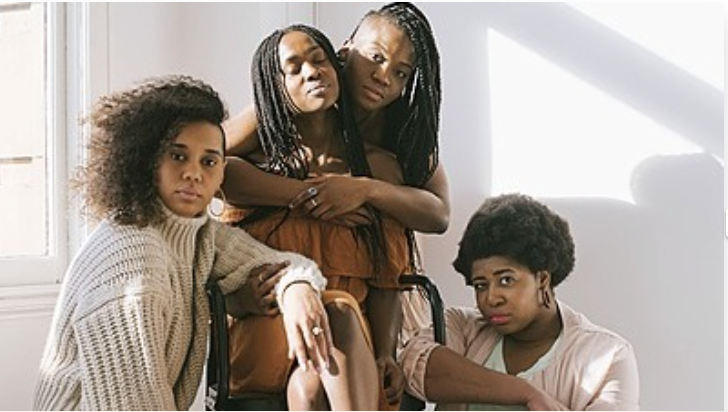 a group of black women posing for the camera