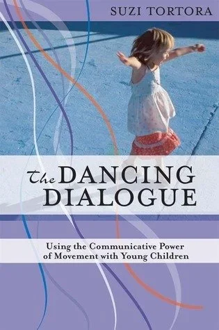 Book cover titled 'The Dancing Dialogue' by Suzi Tortora, featuring a young girl in a white dress and pink shorts dancing in a swimming pool.