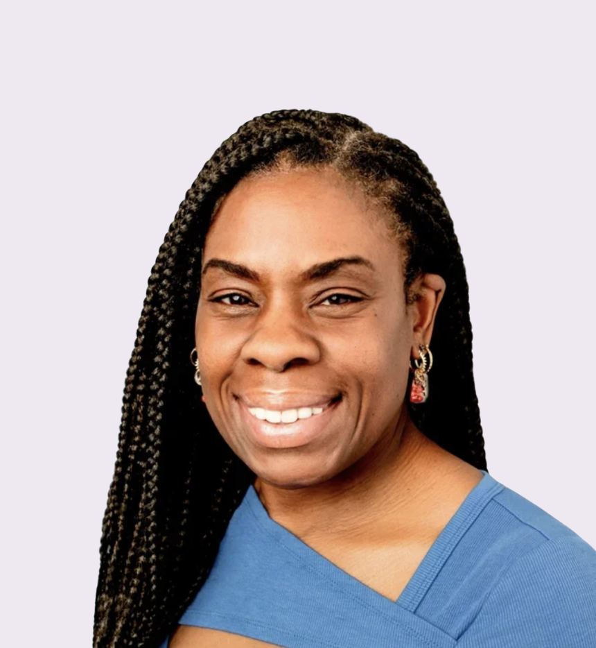 A smiling woman with long braided hair, wearing earrings and a blue top, against a light purple background.