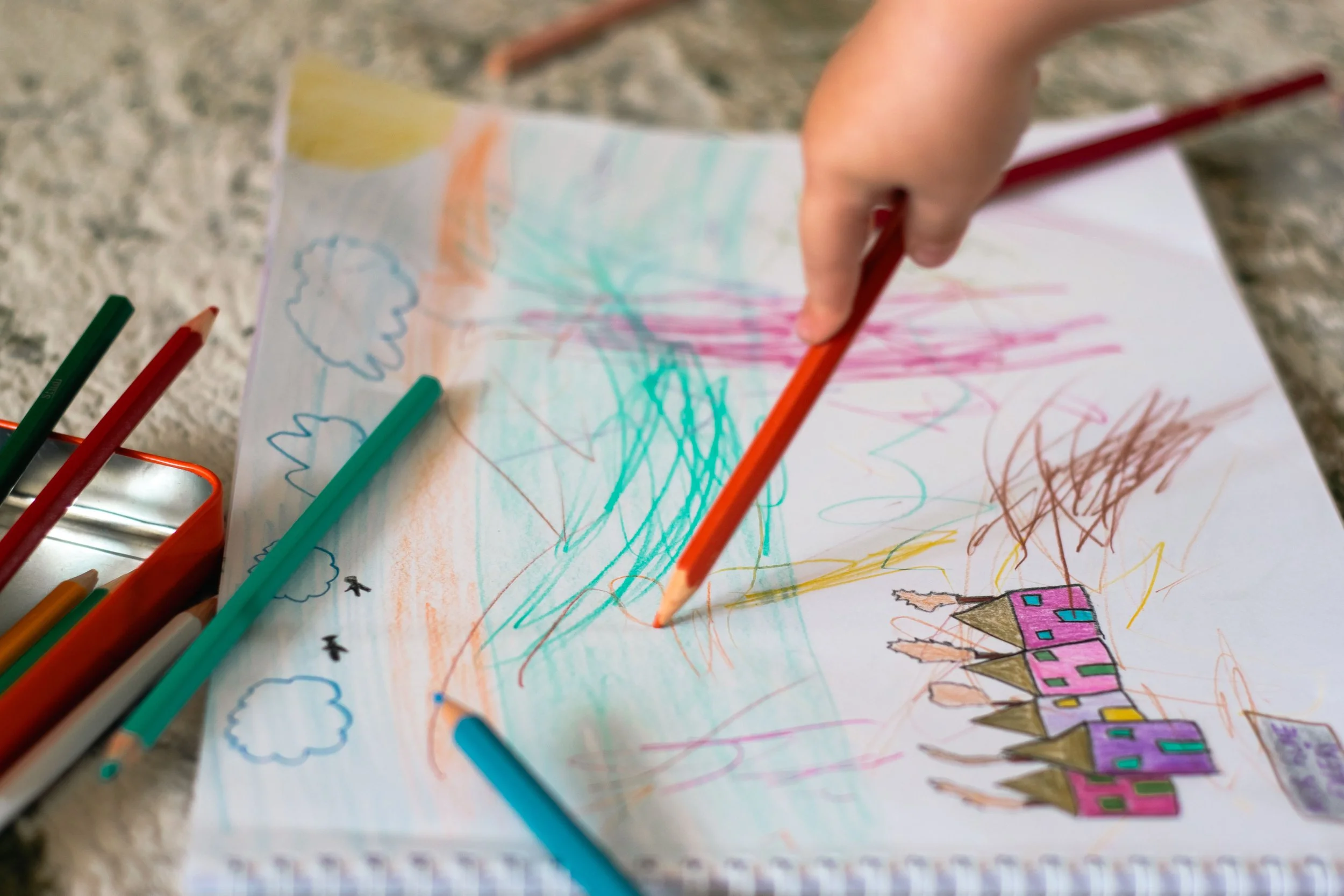 a child drawing with pencil color