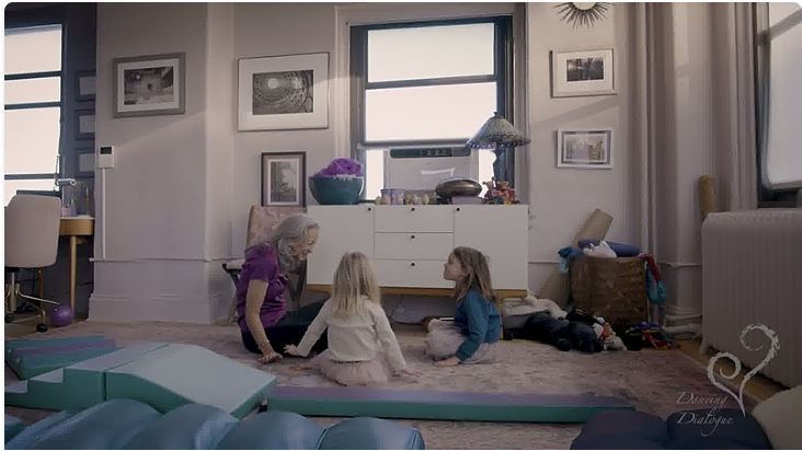 an image of Dr. Tortora talking with two little girls