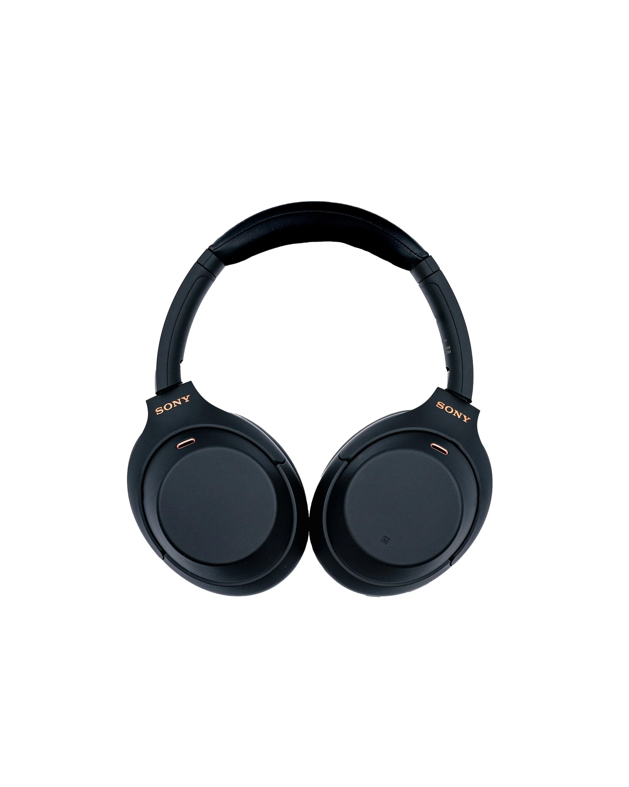 Black Sony over-ear headphones with a padded headband, placed against a white background.
