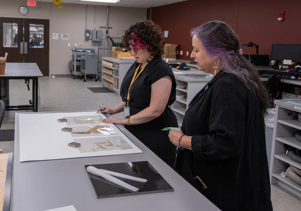 Researchers reviewing personnel records