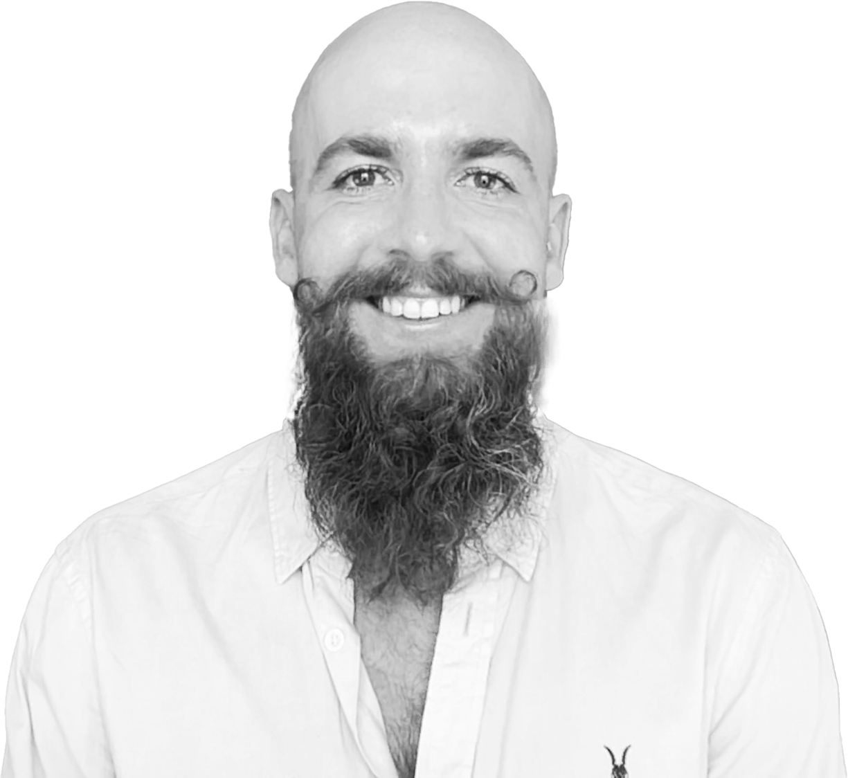 Black and white portrait of a smiling man with a shaved head, a full beard, and a styled mustache, wearing a light-colored button-up shirt with a small eagle logo on the chest