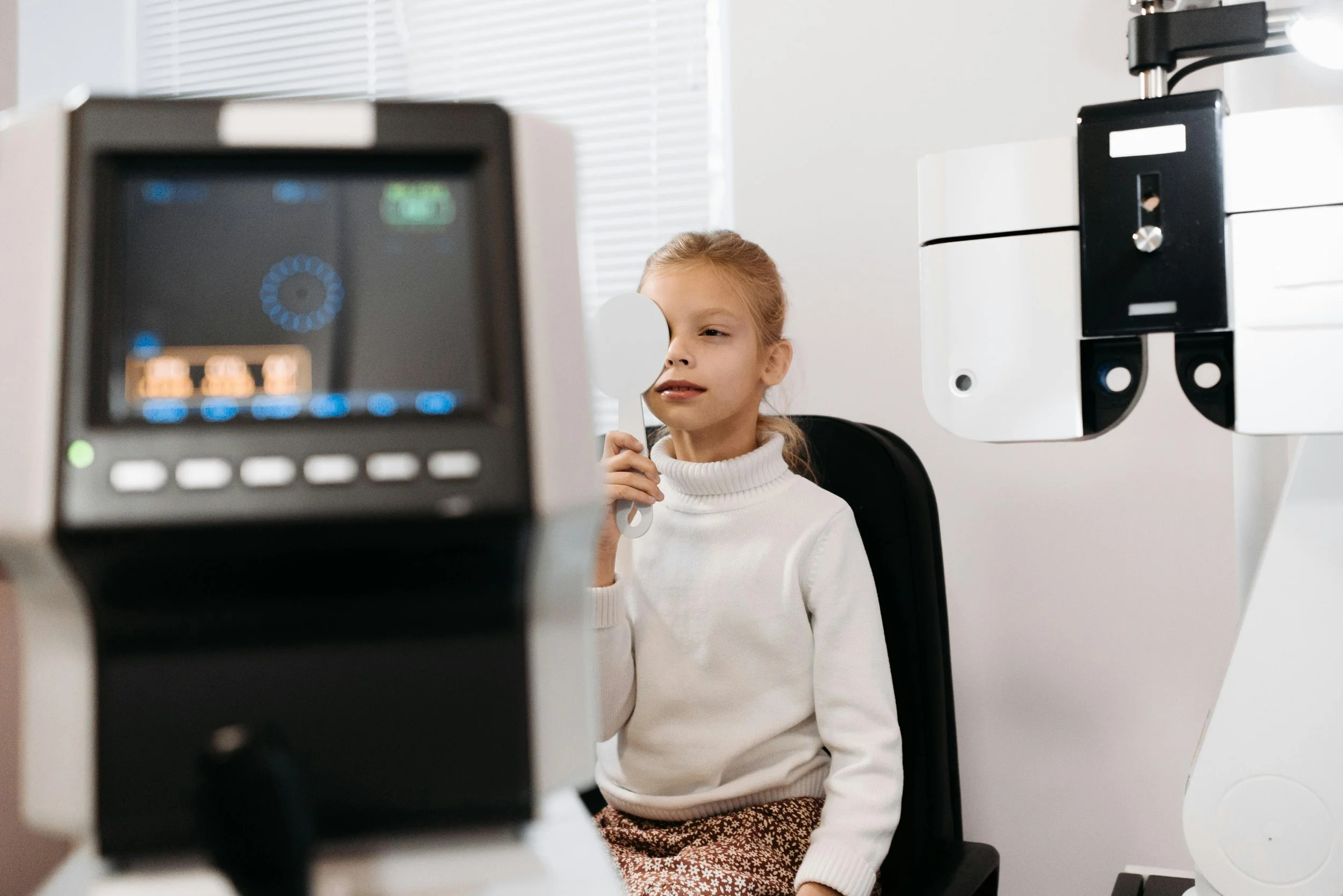 A child with myopia or nearsightedness taking an eye test at Apex Vision Group
