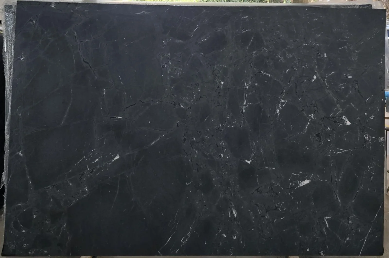 A large black marble slab with white veining.