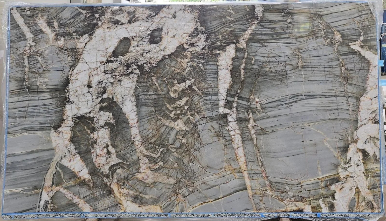 A large marble slab with intricate gray, white, and brown veining patterns.