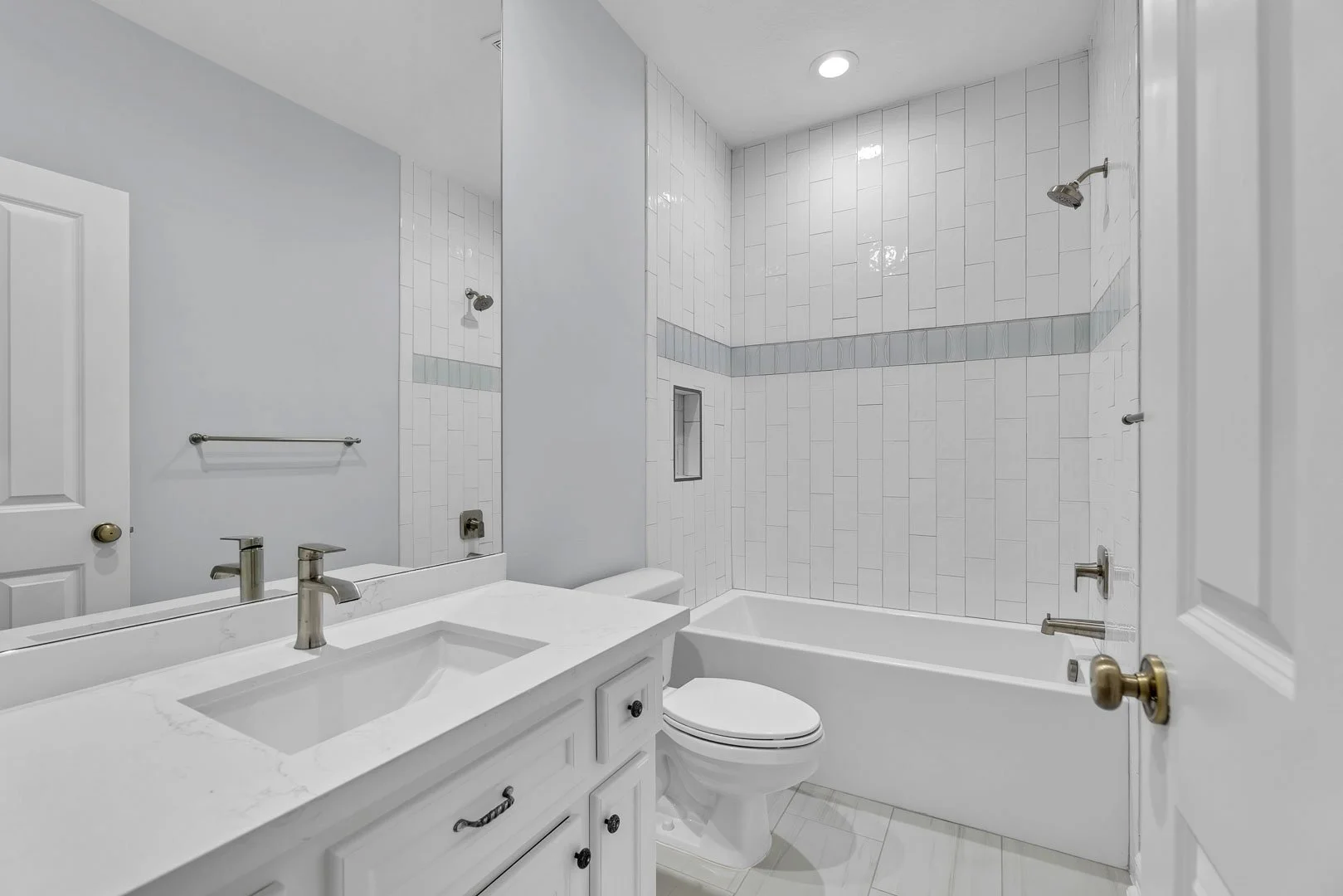 montgomery-houston-real-estate-photography-tx-secondary-bathroom-elegant-luxury-white-tile-marble.jpg