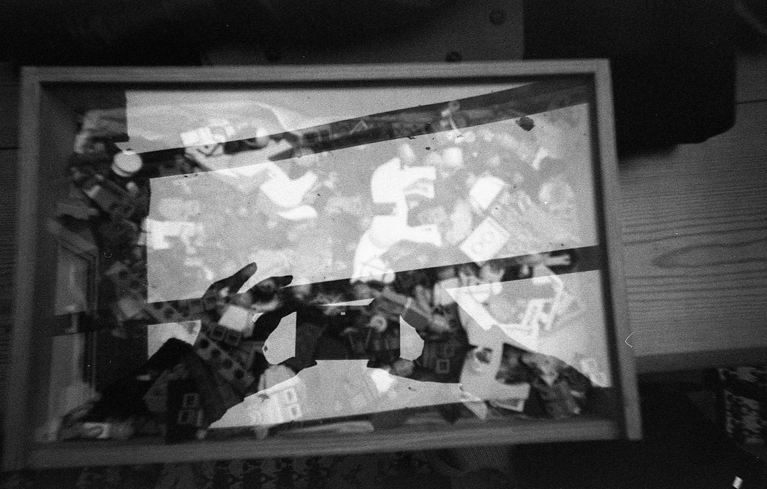 Olivia reflected in glass, taking a photograph with a camera