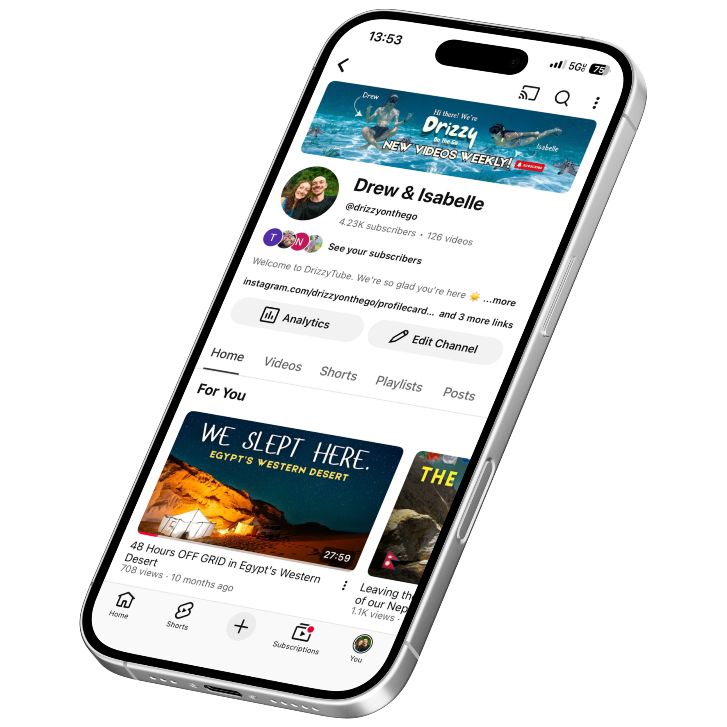 Smartphone displaying the YouTube channel page for Drew & Isabelle, with a banner featuring water sports, and videos about Egypt's desert.