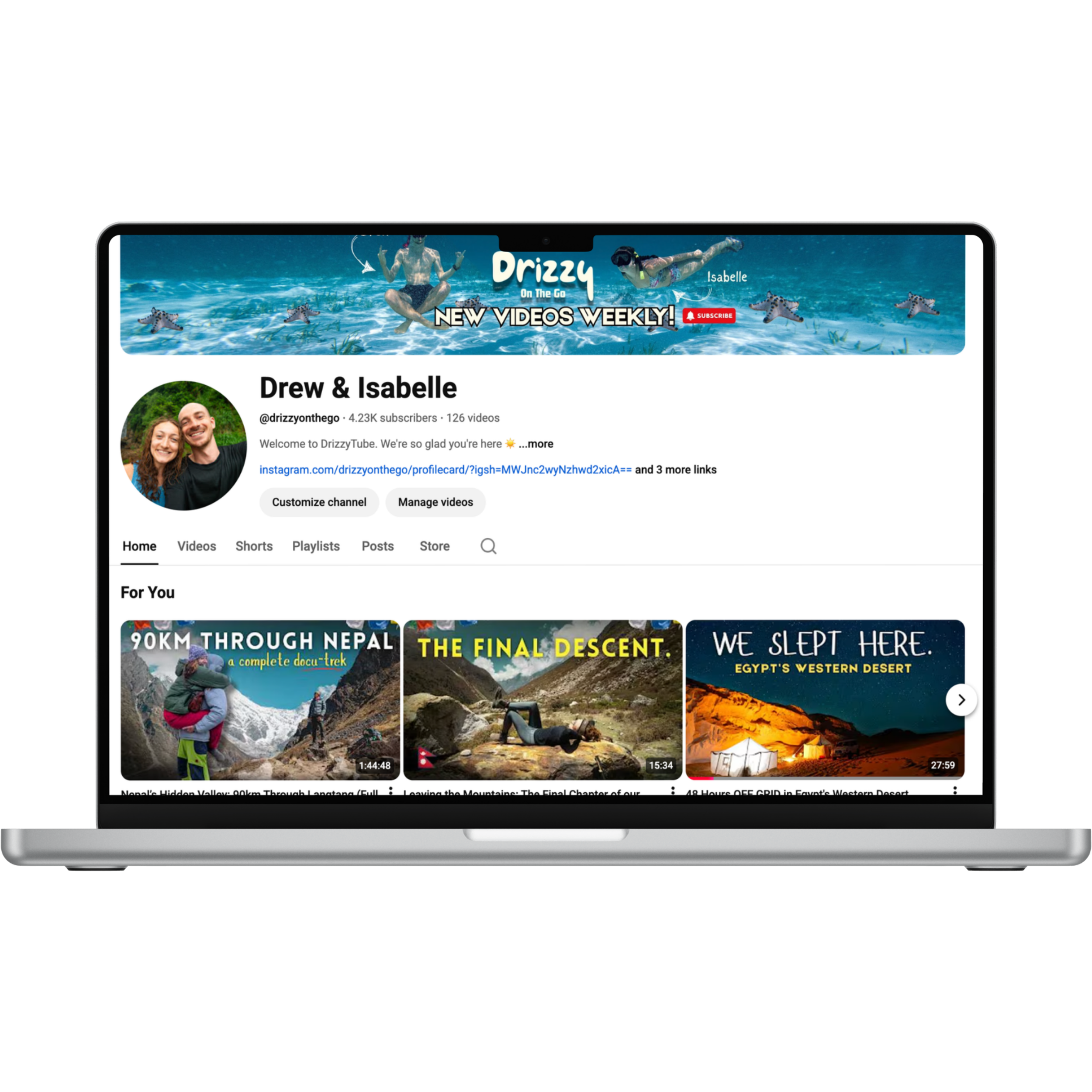Computer screen displaying a YouTube channel page for Drew & Isabelle, with banners, profile picture, and video thumbnails about outdoor adventures and travel.