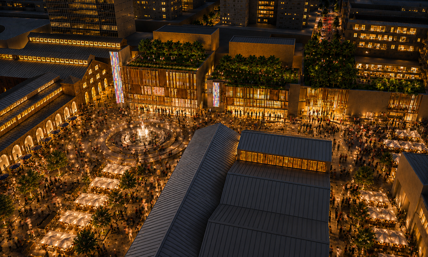 Night aerial view of a lively city square with a central fountain, surrounded by buildings with illuminated windows, outdoor seating under umbrellas, and crowds of people walking around.