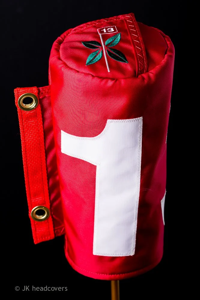 Red and white sports flag with a green marijuana leaf and the number 13 on a black background.