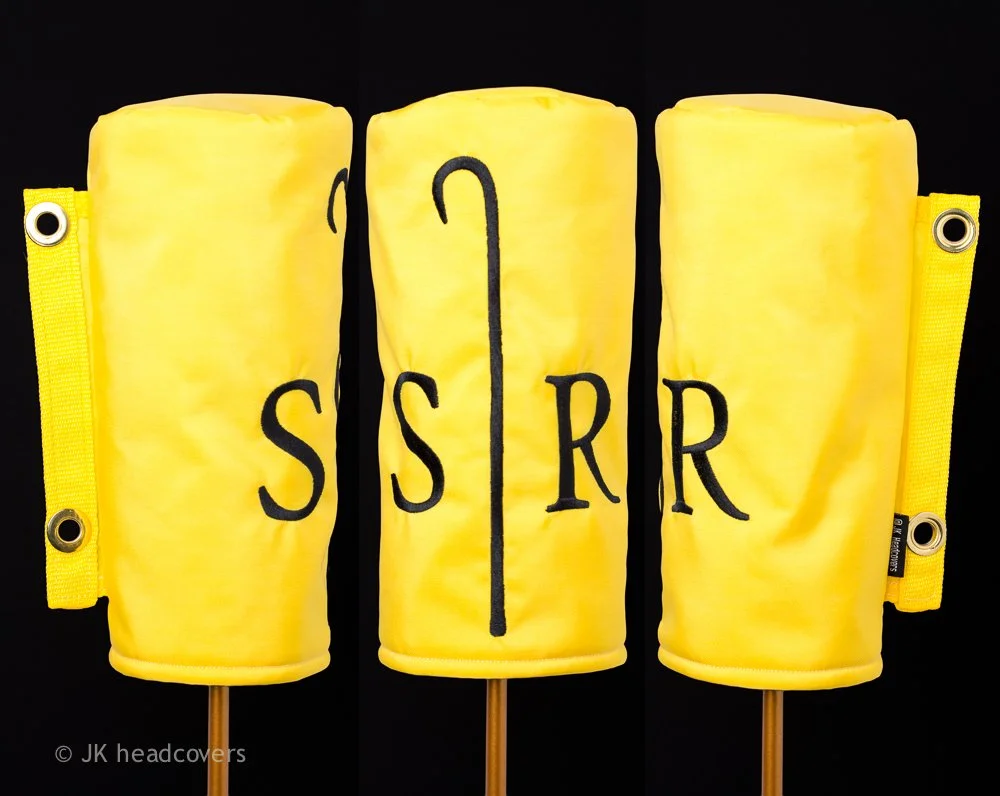 Yellow foam props resembling beer mugs with black letters and a tube symbol, arranged to spell 'SSR' with a black tube in the middle and yellow straps on the sides.