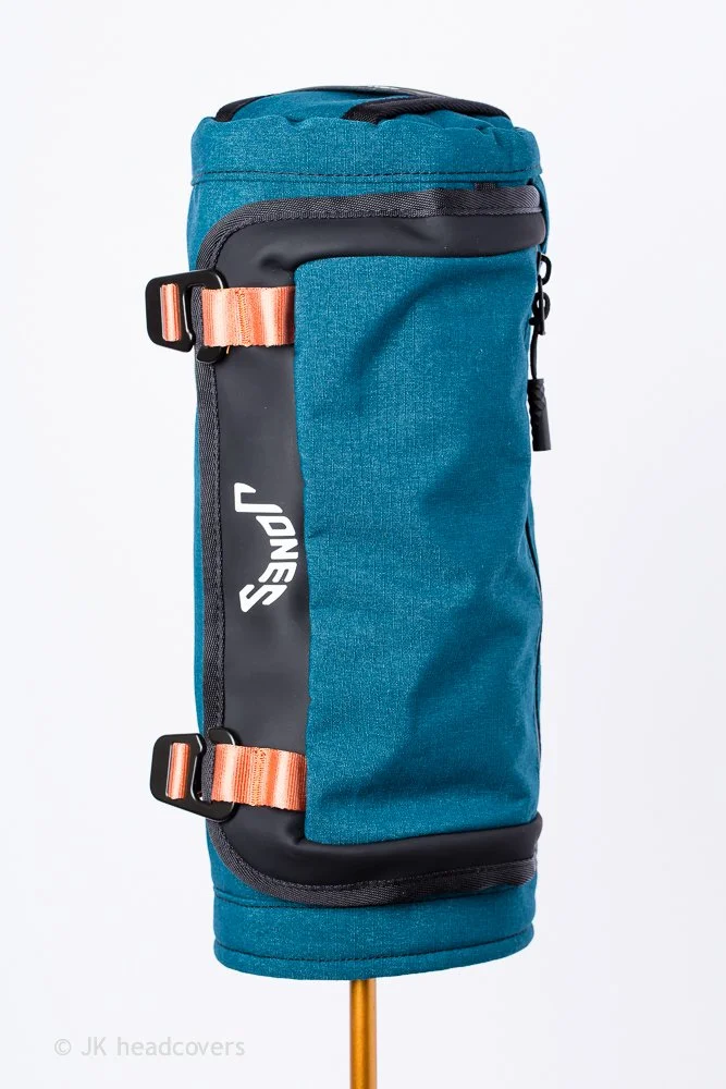 Blue and black Wilson sports bag with orange straps, standing upright against a white background.