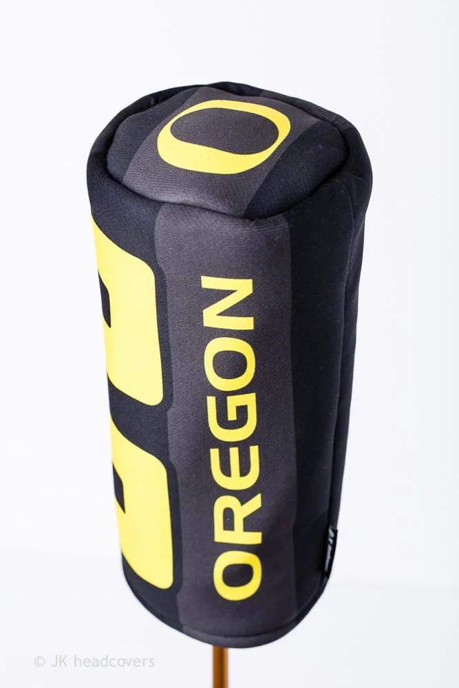 A black and yellow golf club headcover with the word 'OREGON' printed vertically on it.