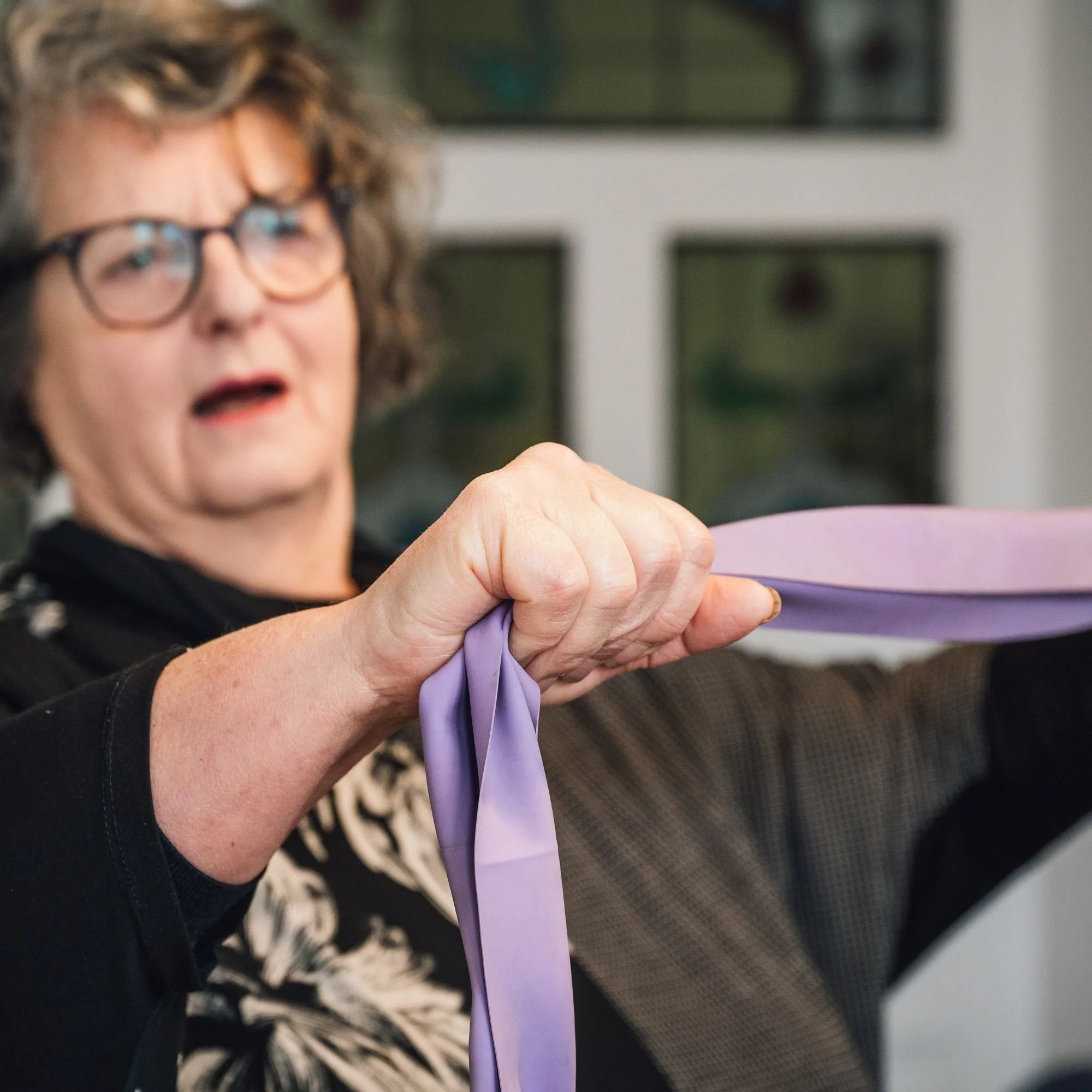 Adult using a resistance band for strength and mobility.jpg