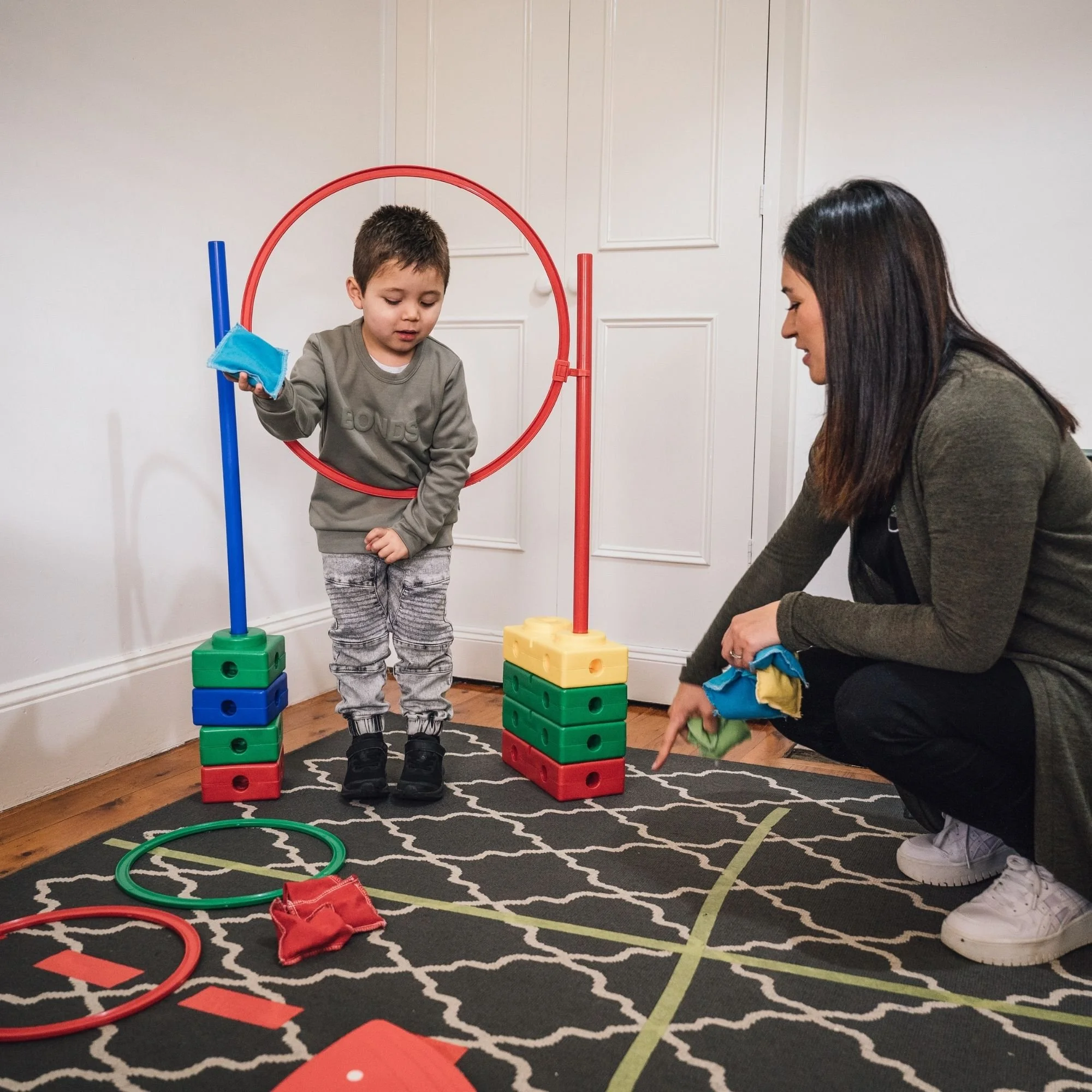Child completing a movement activity with a hoop and obstacles.jpg