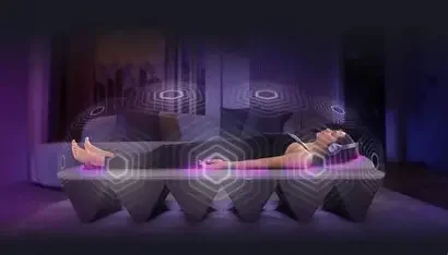 A woman lying laying in a calm setting receiving sound therapy.