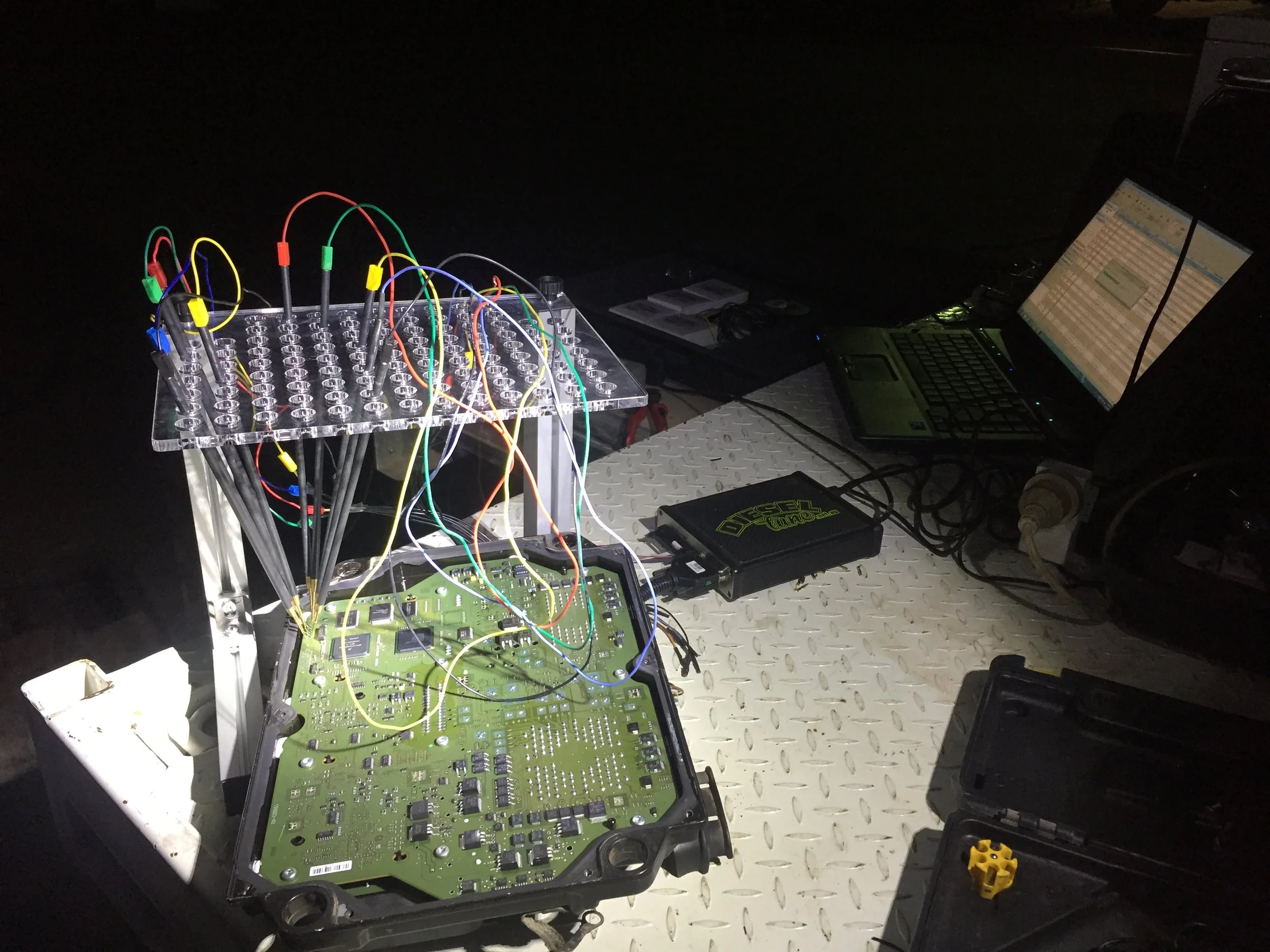 A workbench with electronic components, circuit boards, wires, and tools