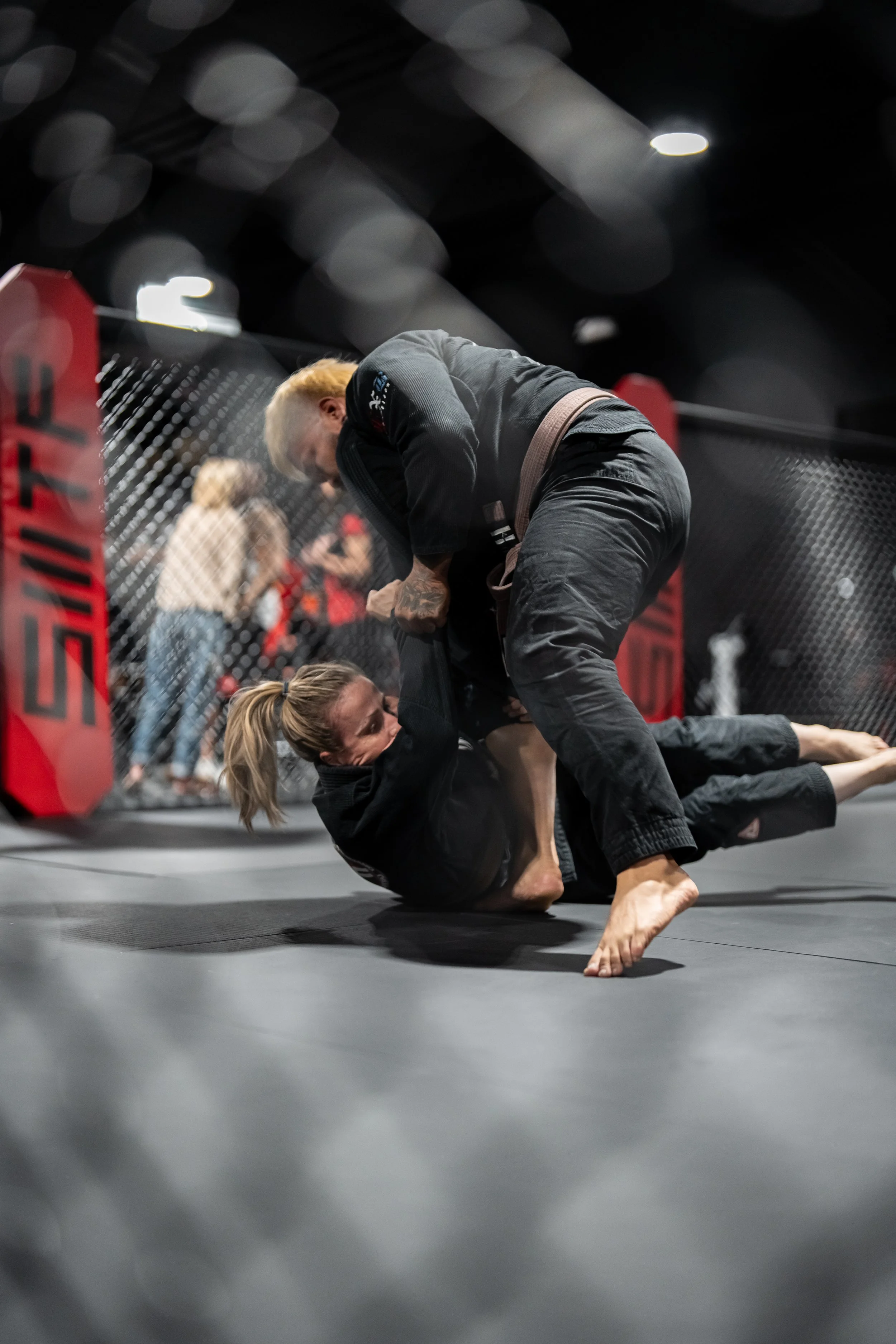 Male and female athletes practicing Brazilian Jiu-Jitsu inside Self Made Training Facility Temecula Valley, showcasing high-level martial arts training in a premium gym environment.