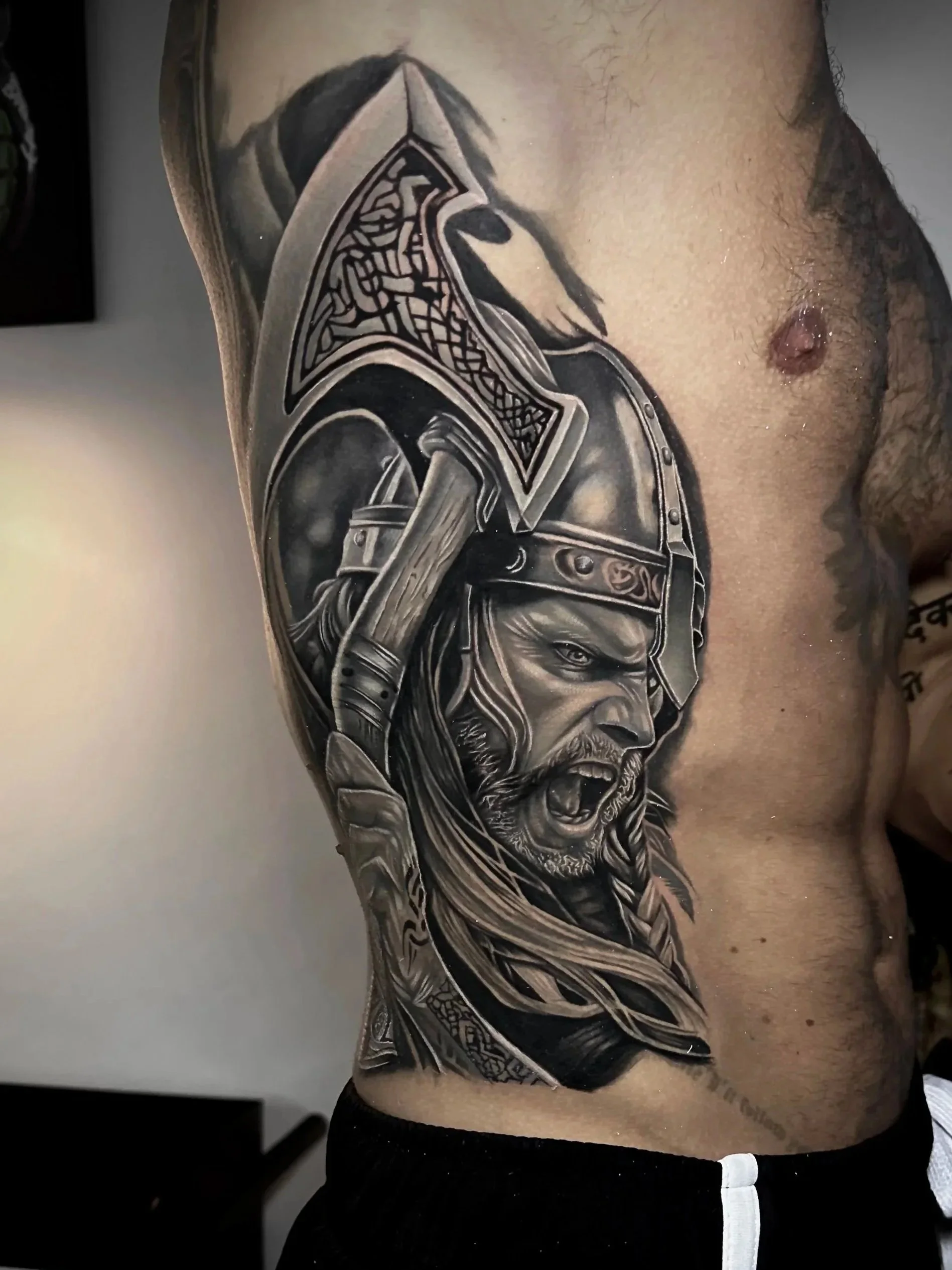 Realism with detailed black and gray tattoo of a fierce warrior