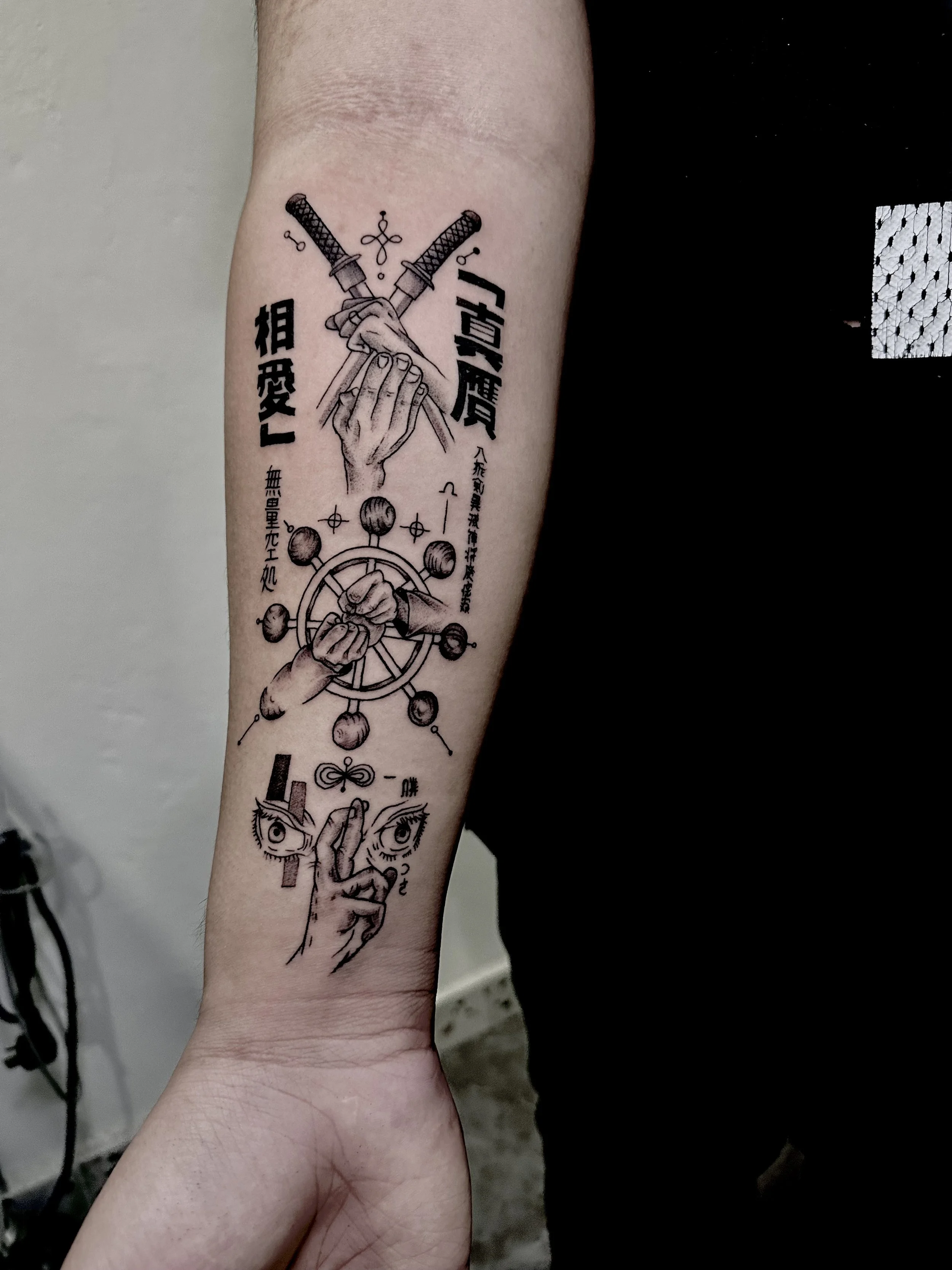 Tattoo featuring crossed swords, hands, and Japanese characters.