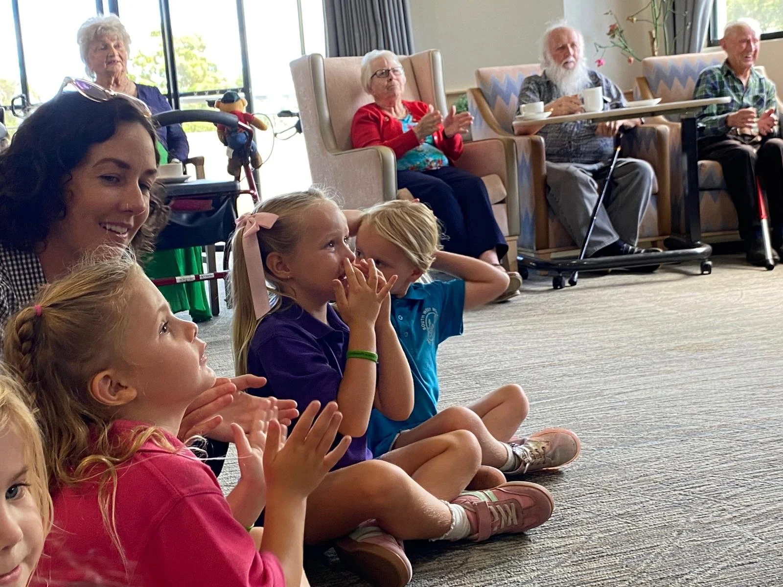 Elderly people with preschoolers visiting and enjoying each others company