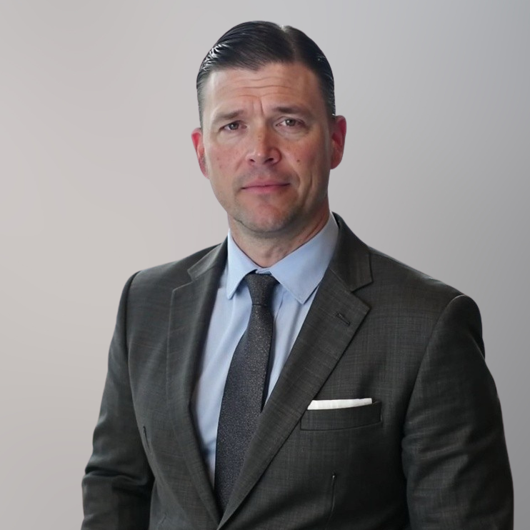 Dan Dempsey headshot on a gray background