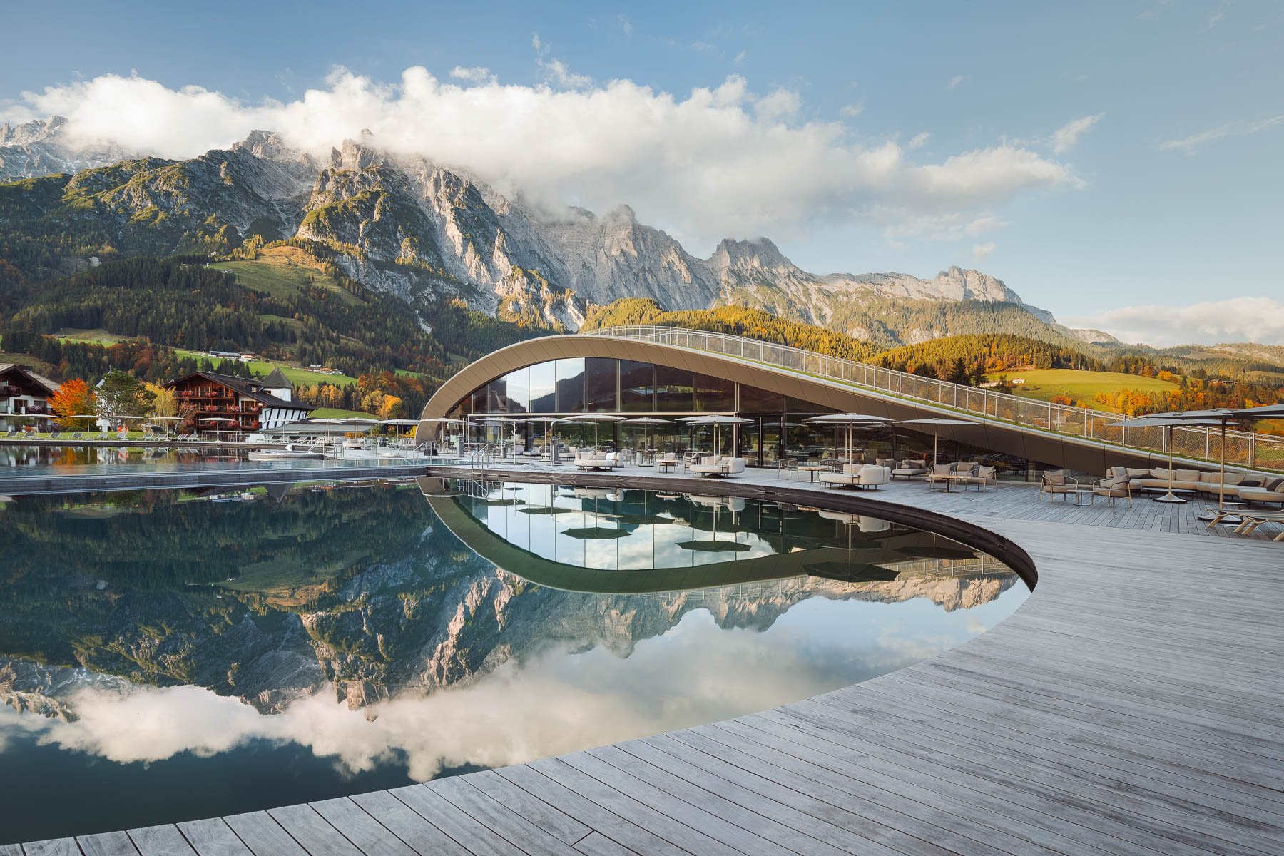 Modern interior of ATMOSPHERE Spa at Krallerhof with design pool and alpine scenery.