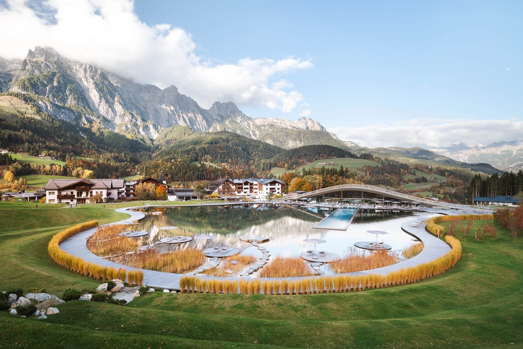 Krallerhof wellness pool with Alpine panorama in autumn.