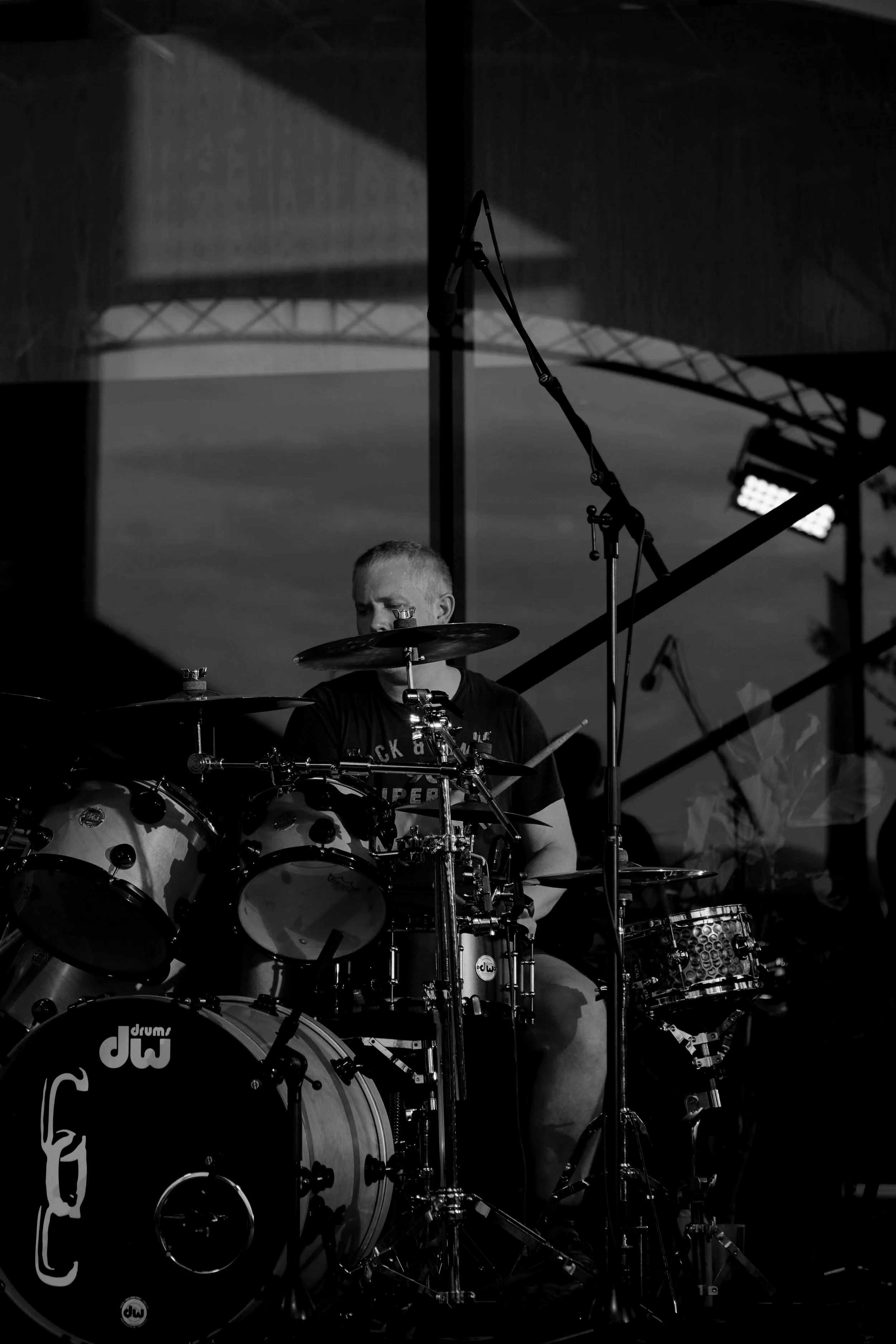 Session drummer Simon Barbour plays a rock groove on stage as the sun sets