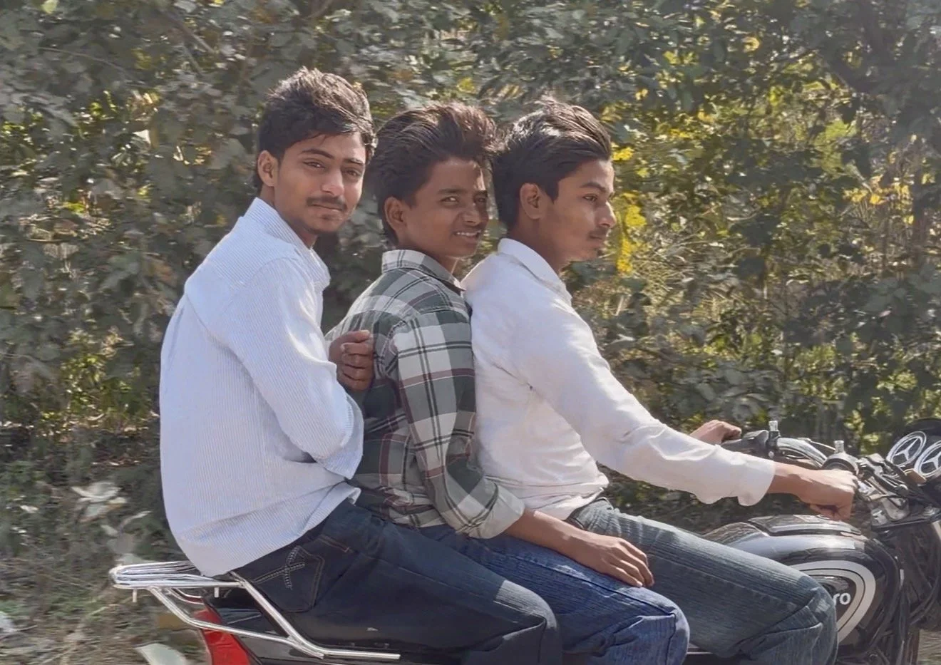  Three people riding on one motorbike during our journey across Punjab to Amritsar 