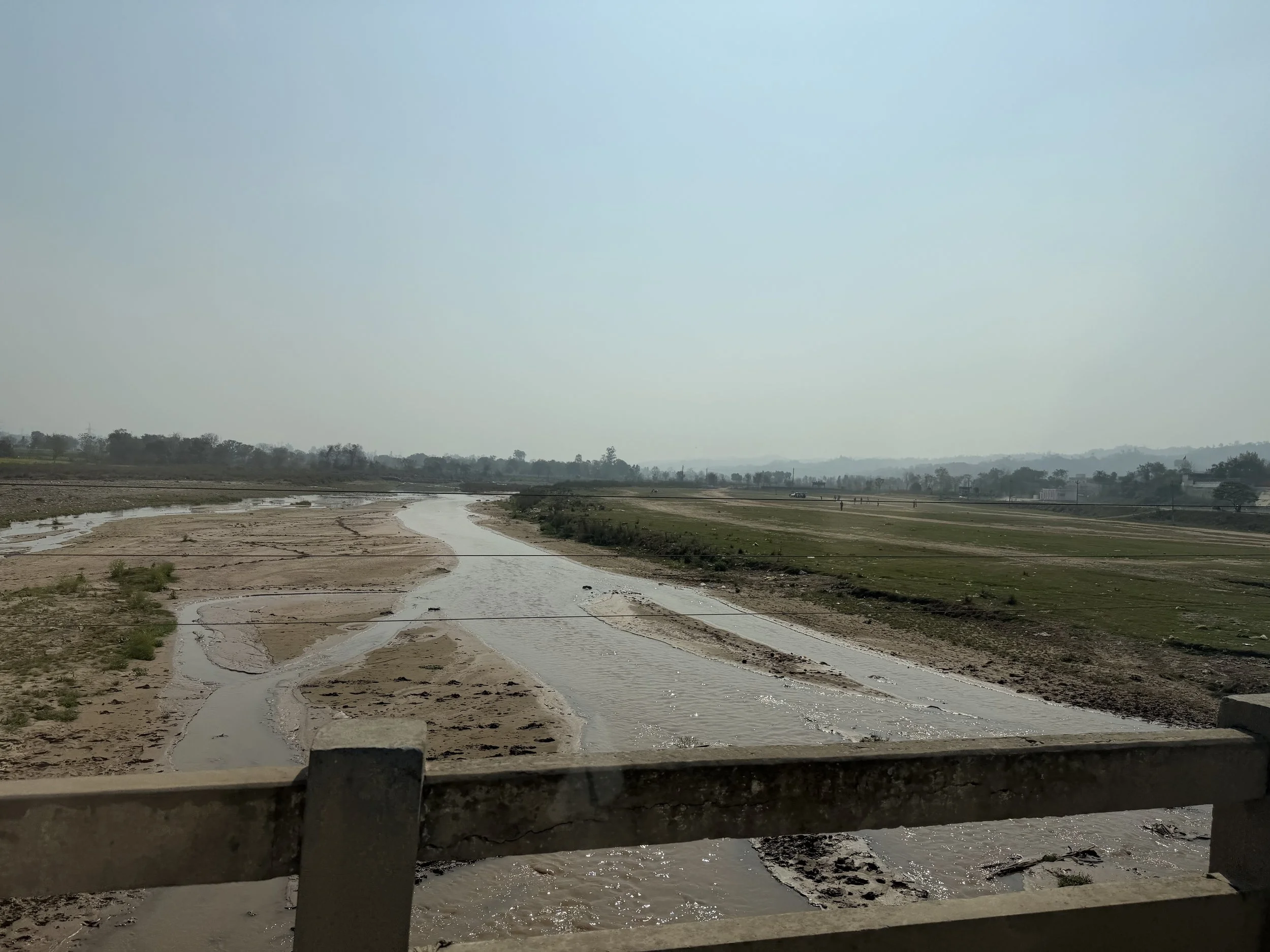View of a river and farmland on the plains of Punjab during our drive to Amritsar
