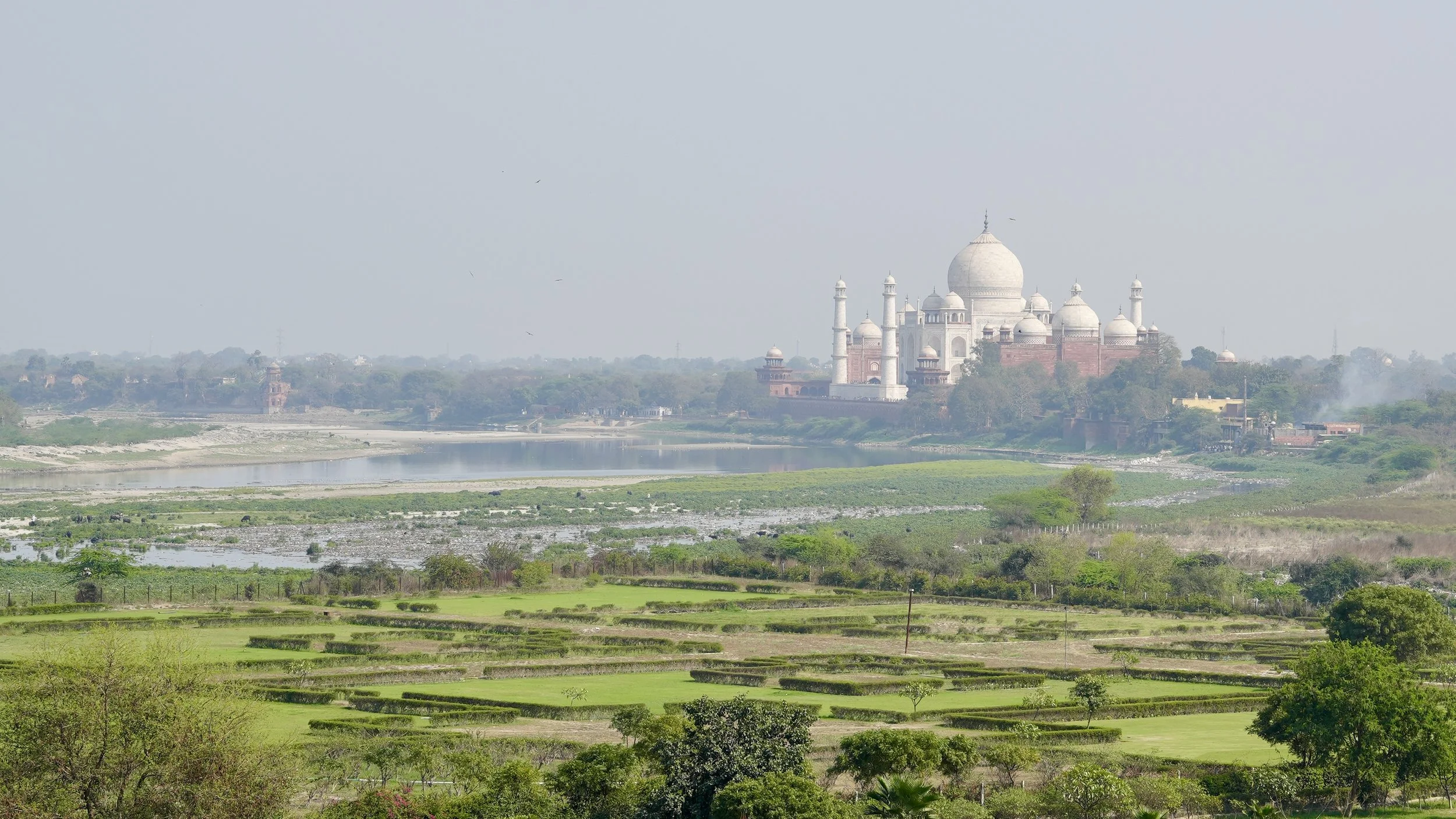 View of the Taj Mahal from Agra Fort showing the white marble mausoleum across the river